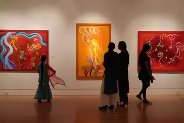 Visitors enjoy an installation at the Triton Museum of Art