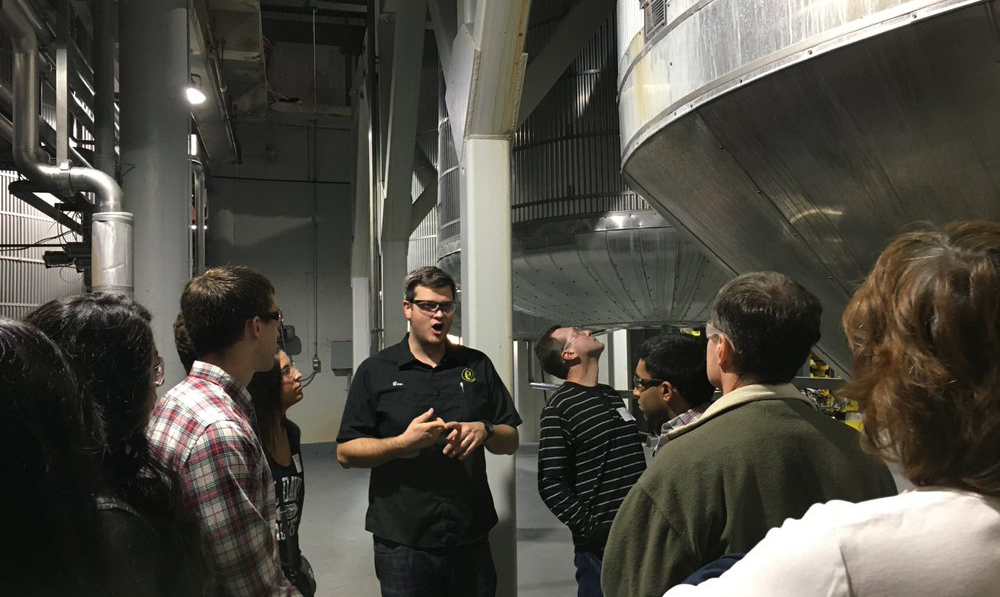 people taking a tour of the Gordon Biersch brewing facility