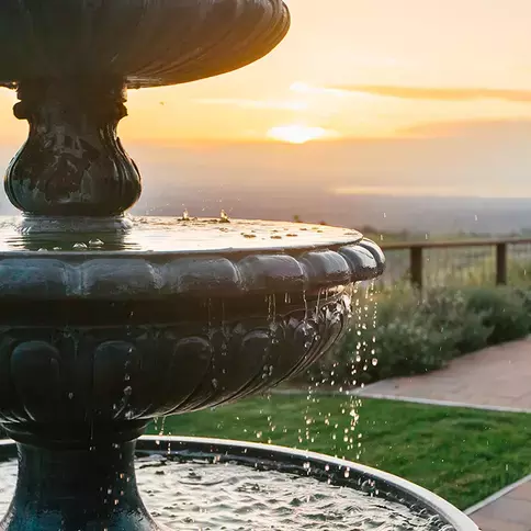 A fountain with a gorgeous sunset background on Mount Hamilton